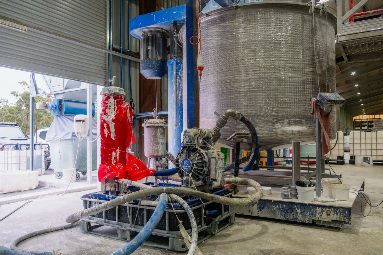 Graco Quantm pump and stainless paint tank on the floor at Crystalite
